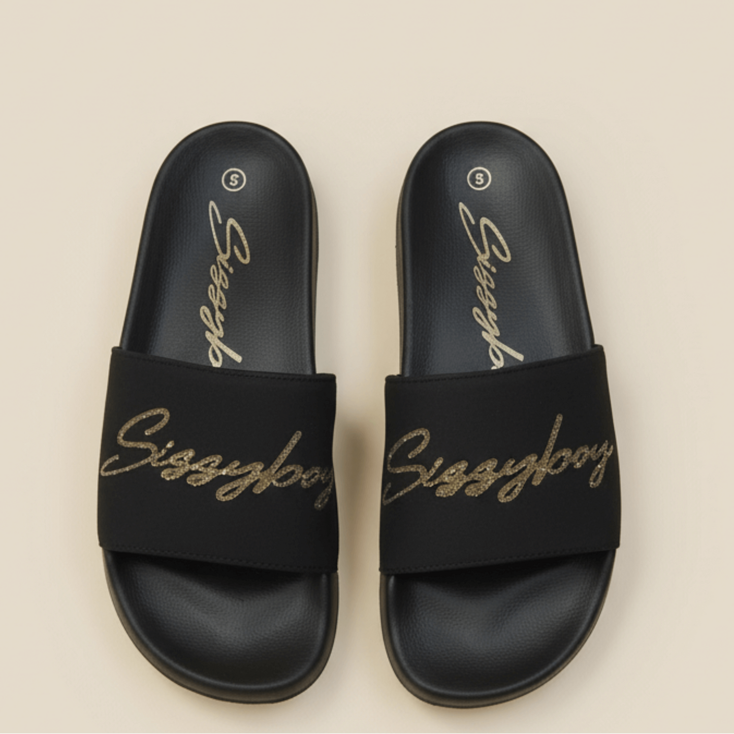 Sissy Boy slides featuring gold cursive branding on wide straps.