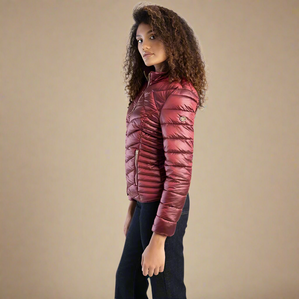 Lightweight burgundy puffer jacket by Sissy Boy featuring a flattering quilted pattern and zippered pockets.