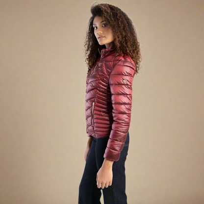 Lightweight burgundy puffer jacket by Sissy Boy featuring a flattering quilted pattern and zippered pockets.