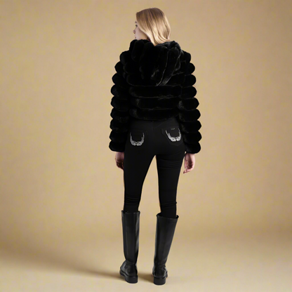 Black cropped faux fur jacket with a hood by Sissy Boy, combining warmth and modern style for colder seasons.