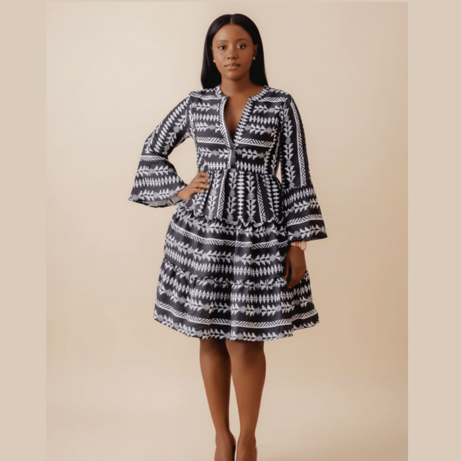 Black boho print dress with bell sleeves and tiered skirt,