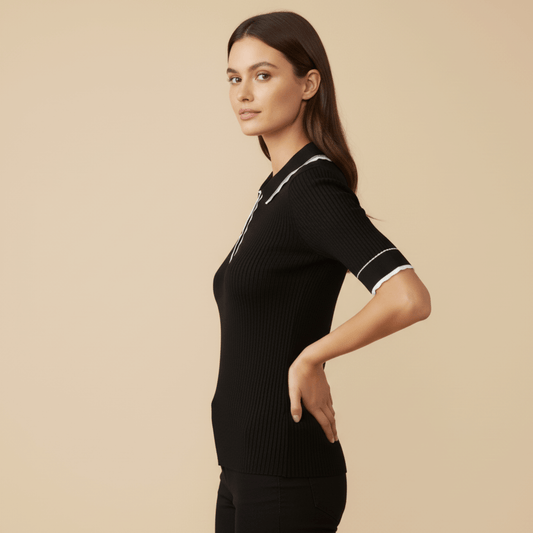 Women’s black ribbed knit golf shirt with short sleeves and collar