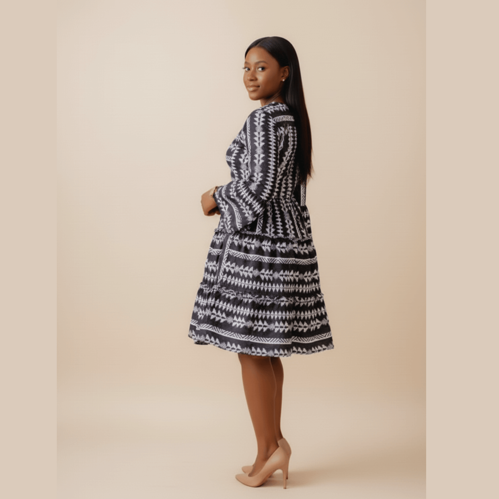 Elegant black ethnic patterned dress for women, featuring flared sleeves and fitted waist