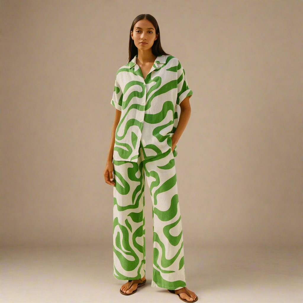  Modern Dynasty’s Moolit Majesty co-ord set in white and green, featuring a loose-fit short-sleeve button-up shirt and matching wide-leg trousers 