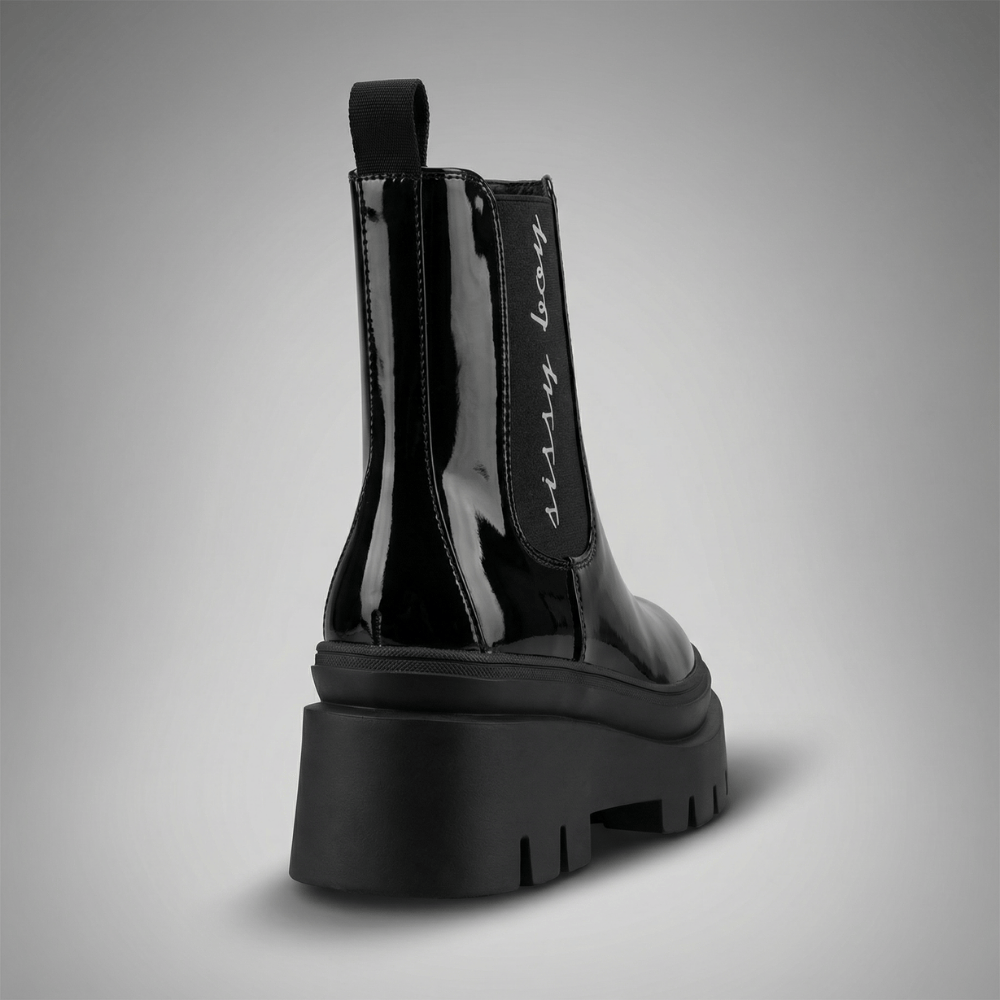 Black patent chelsea ankle boots with statement chunky outsoles and pull tab detail by Sissy Boy