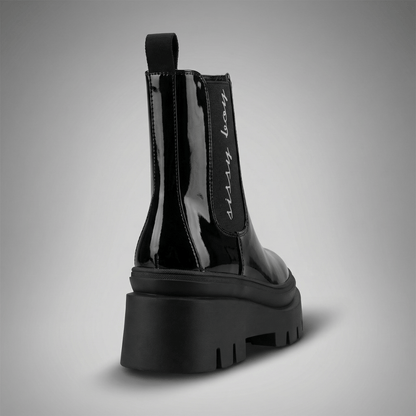 Black patent chelsea ankle boots with statement chunky outsoles and pull tab detail by Sissy Boy