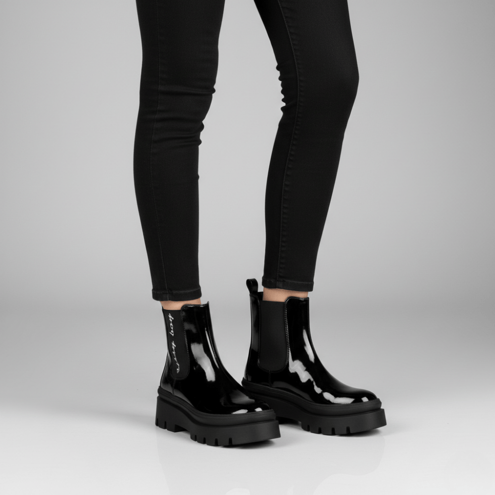 Alma black patent ankle boots by Sissy Boy featuring glossy finish and bold lug sole design