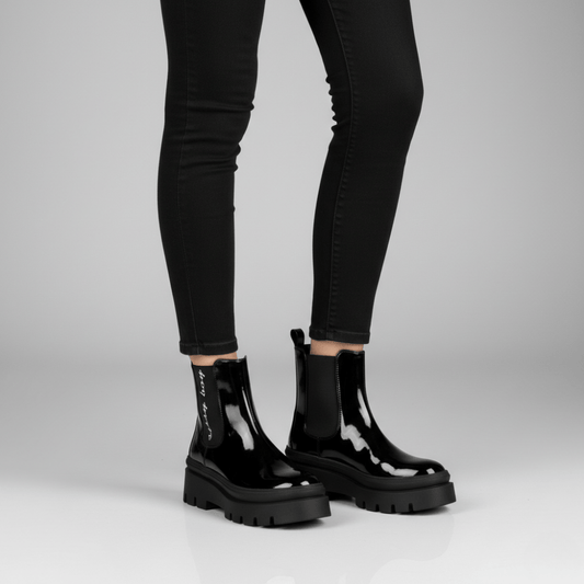 Alma black patent ankle boots by Sissy Boy featuring glossy finish and bold lug sole design