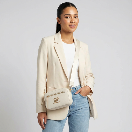 Cream Sissy Boy crossbody handbag with front zip pocket and branded strap